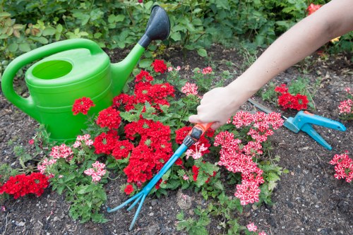 Team preparing equipment before a lawn mowing job in Chessington