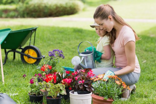 A staff member speaking with a customer outdoors about accessibility needs for a lawn visit.